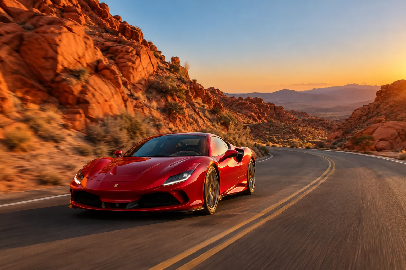 Red Ferrari driving a winding road past red sandstone cliffs near Las Vegas at sunset