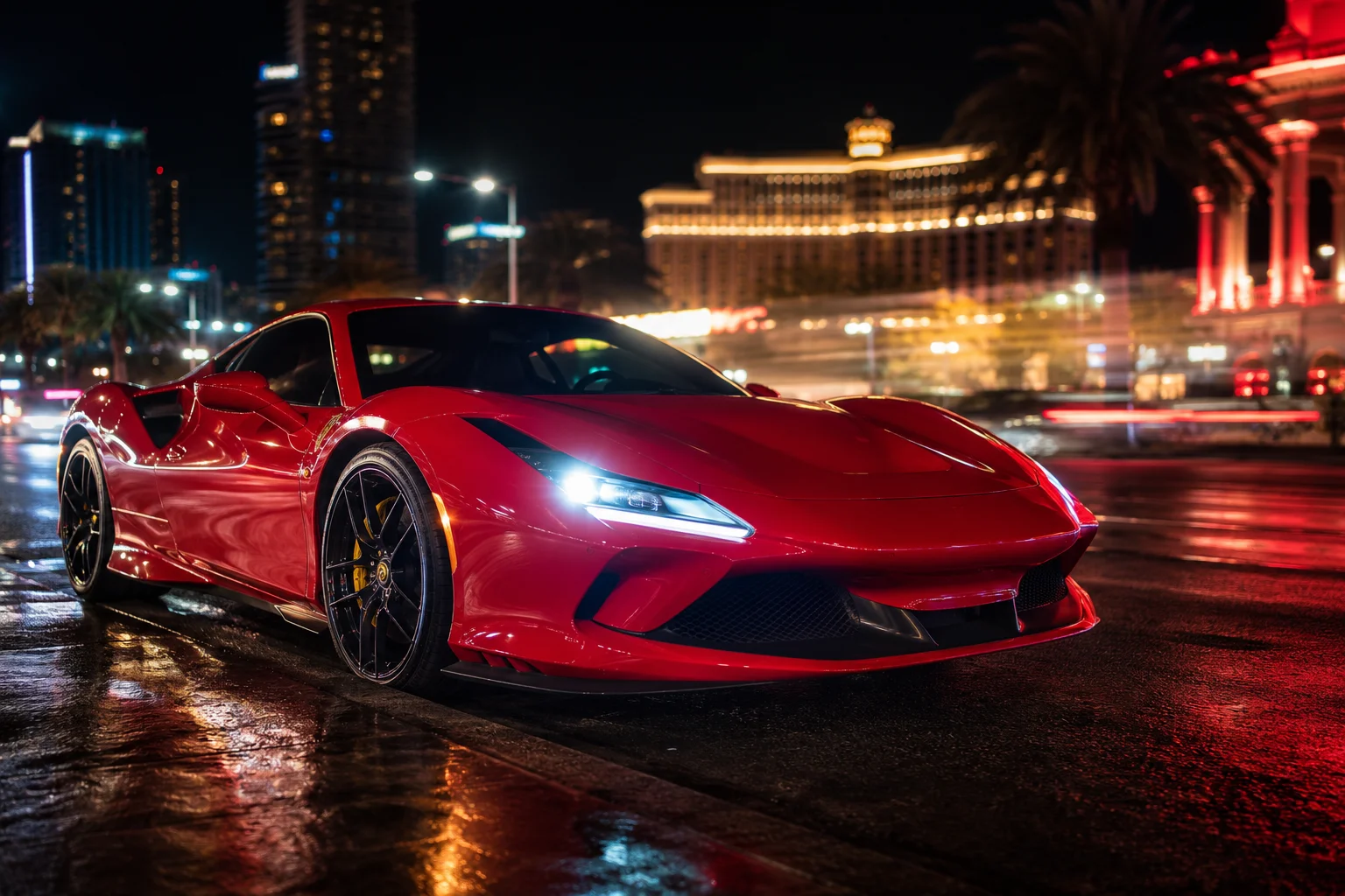 Red Ferrari parked on a neon-lit Las Vegas street at night during race week