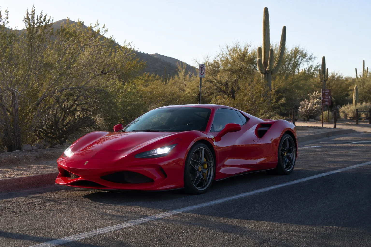 Red Ferrari F8 Tributo on a Sonoran Desert road outside Scottsdale, Arizona